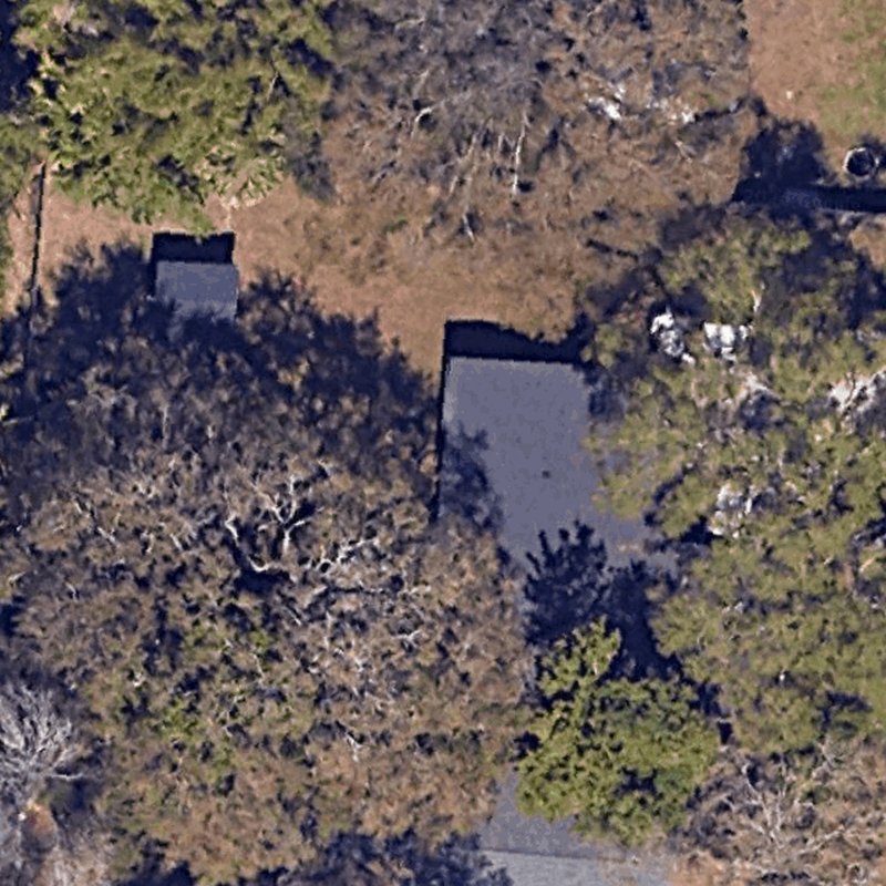 The homeowner's backyard as the satellite image of their address shows it, before the design