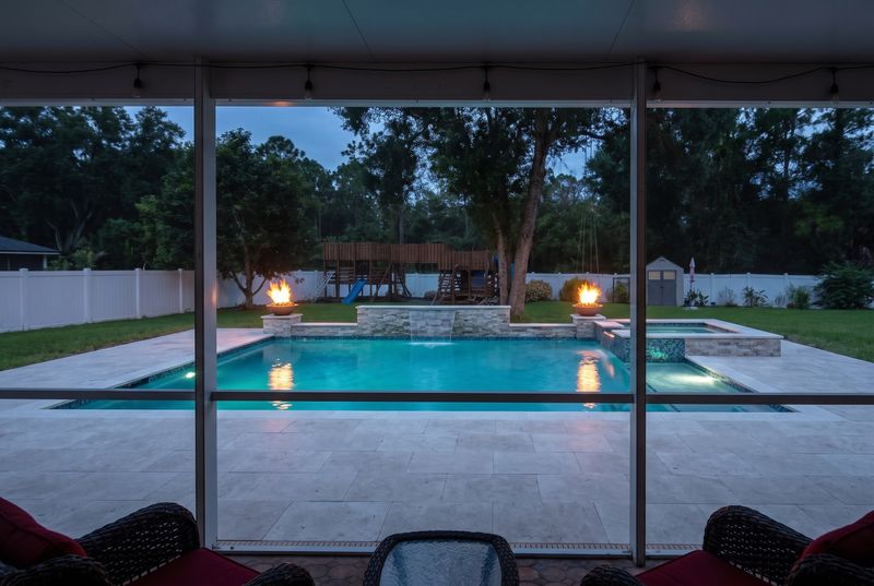 The same backyard photo with the pool the homeowner designed in chat, rendered in place